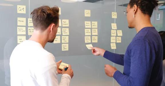 Man holds planning meeting with colleague