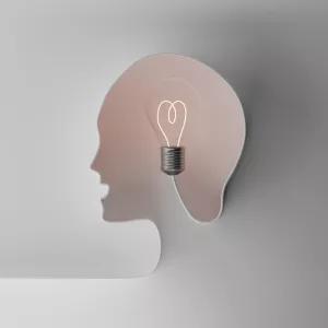 Human head simulated with cord on light bulb illustrating creative idea and intellectual property