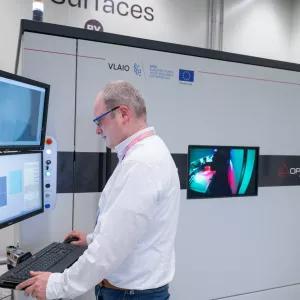 Engineer operating a femtosecond laser installation for texturing surfaces
